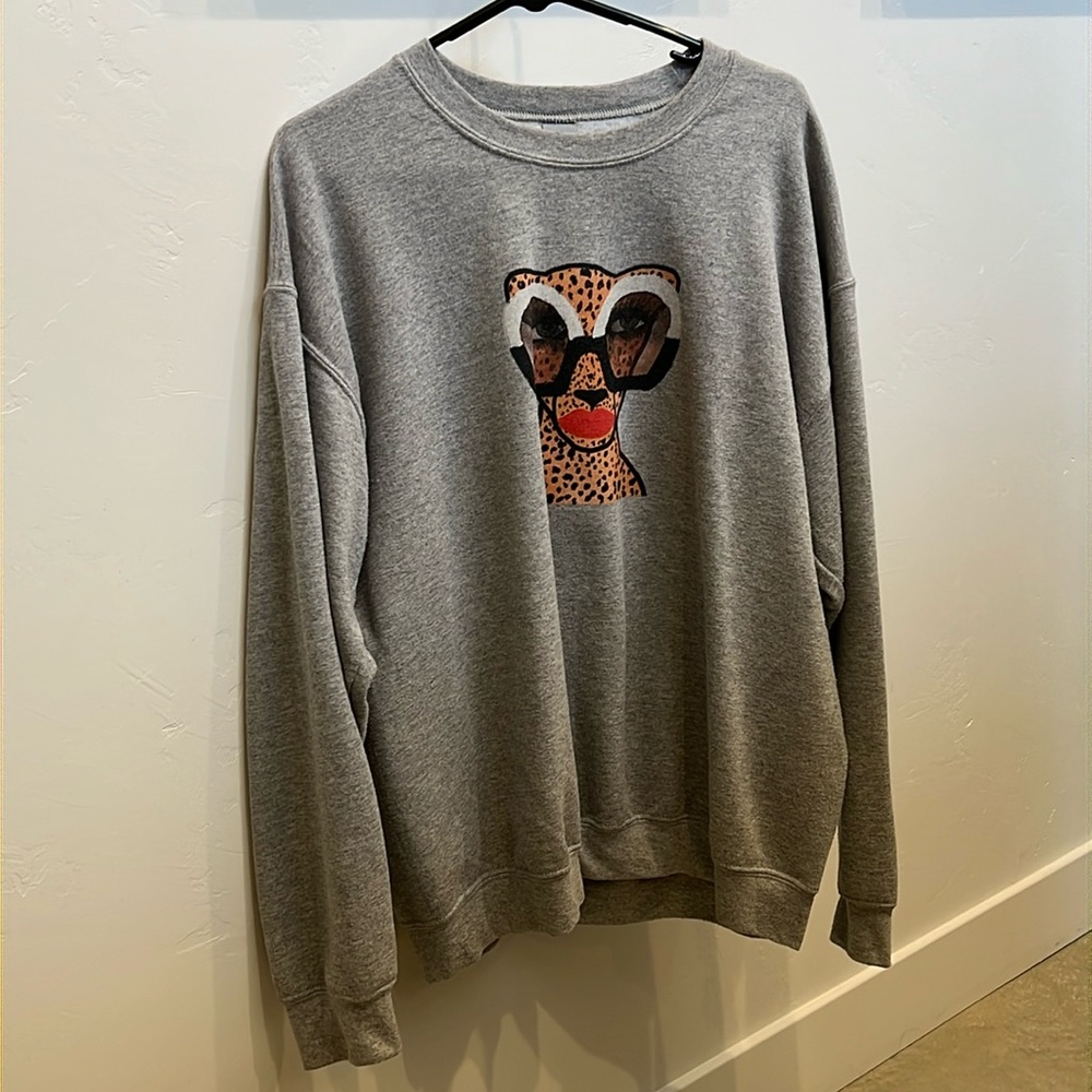 Glasses-wearing cheetah sweatshirt